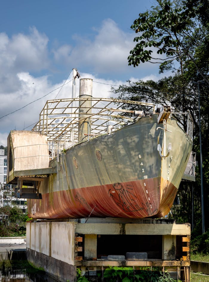 about-01 A ship in dry dock with lush greenery and urban backdrop in Blumenau, Brazil.